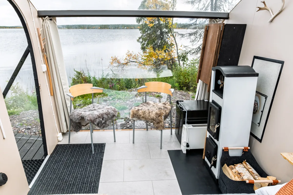 Seating area with two chairs and the fireplace