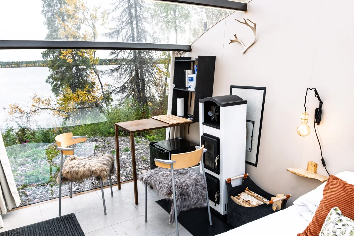 Table with two chairs beside the glass wall