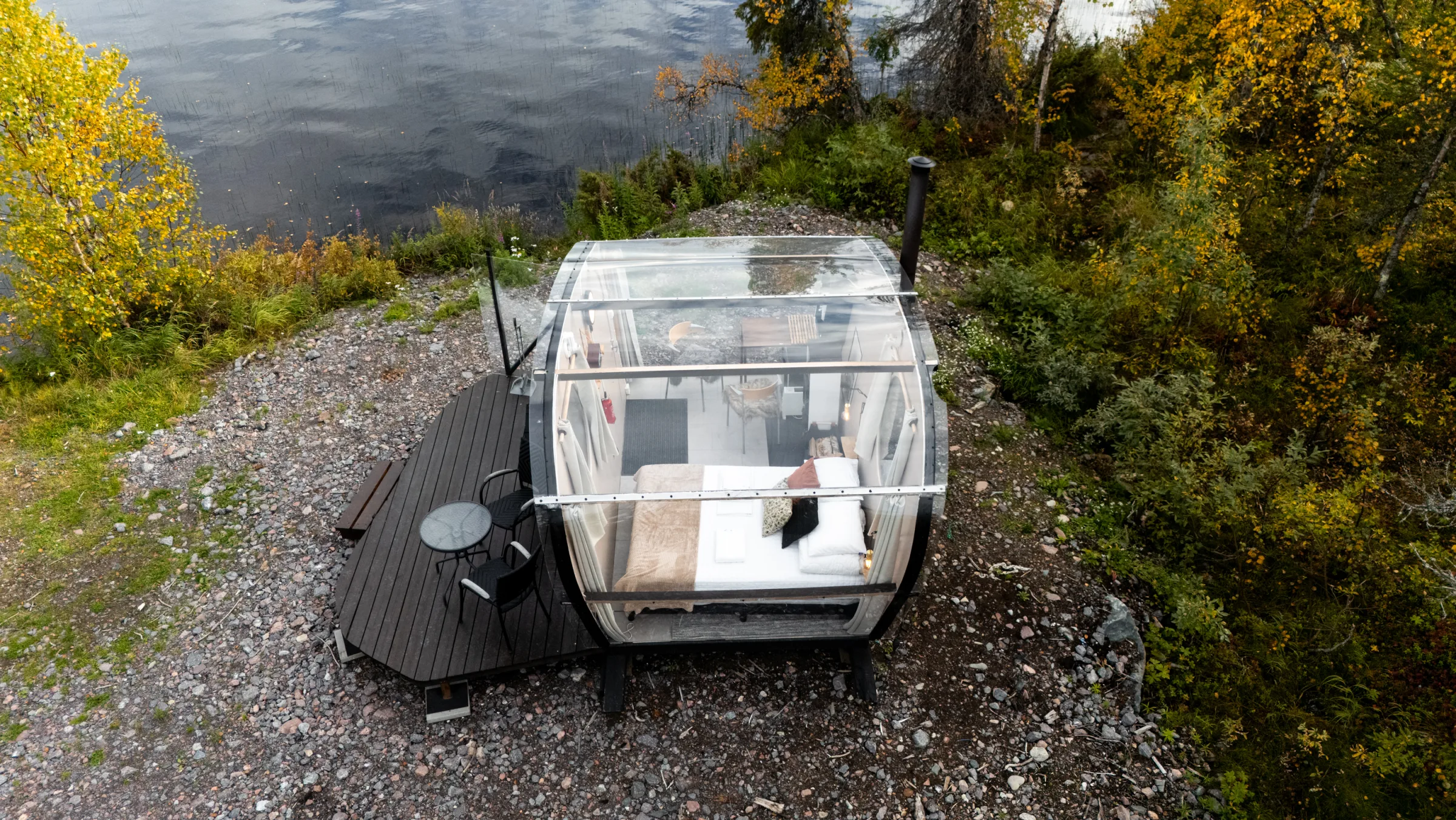 Aerial view of the glass cabin at the water's edge