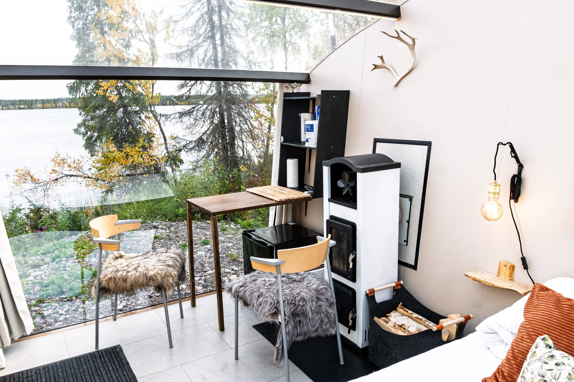 Table with two chairs beside the glass wall